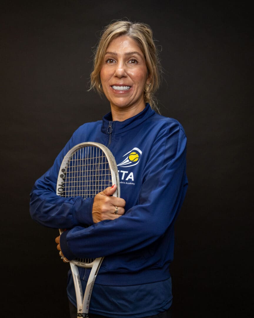 Smiling woman holding a tennis racket